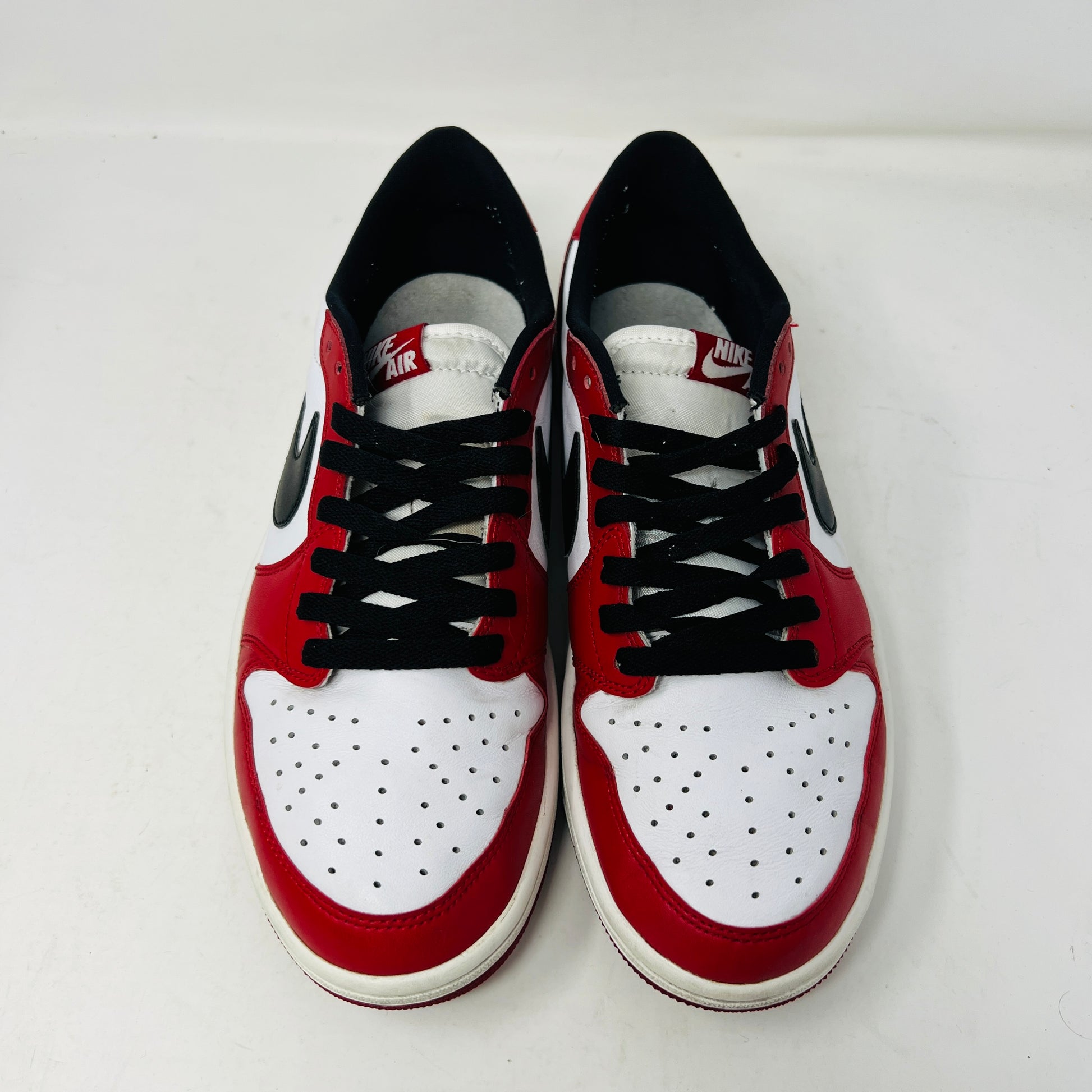 Jordan 1 Retro Low Chicago 2016 sneakers with red, white, and black design, displayed on a Nike box.