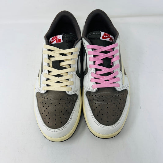 A pair of 2022 Jordan 1 Retro Low OG SP Travis Scott Reverse Mocha sneakers arranged side by side features beige laces on the left and pink on the right. Both have dark brown toe caps with clean white and brown detailing, showing minimal wear.