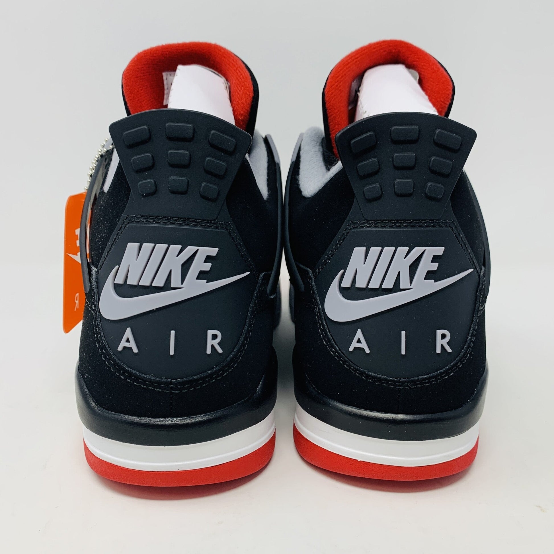 Brand new Jordan 4 Bred 2019 sneakers, black and red, Nike Air logo, hang tag accessory, authentic.