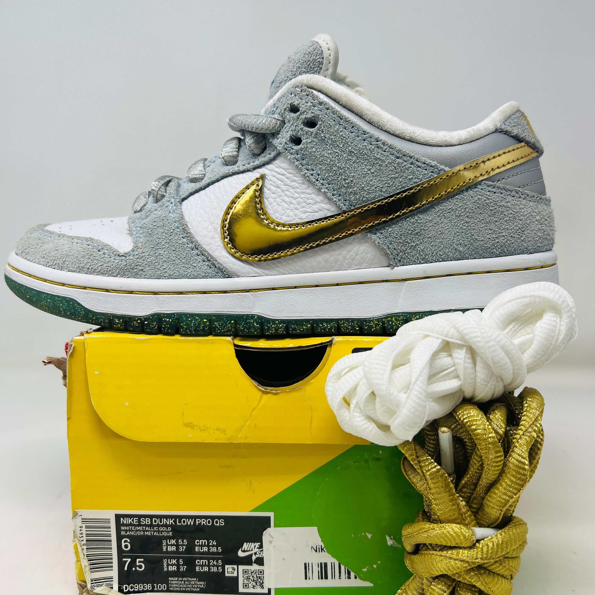 Nike SB Dunk Low Sean Cliver sneakers with clean uppers, showing light wear and slight heel drag, extra laces included.