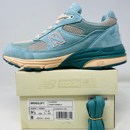 A New Balance 993 Joe Freshgoods Performance Art Arctic Blue sneaker with clean uppers and teal laces, featuring an N logo, rests on its box. The model code is WR993JF1, and the box indicates its womens size 9.5 in teal and beige.