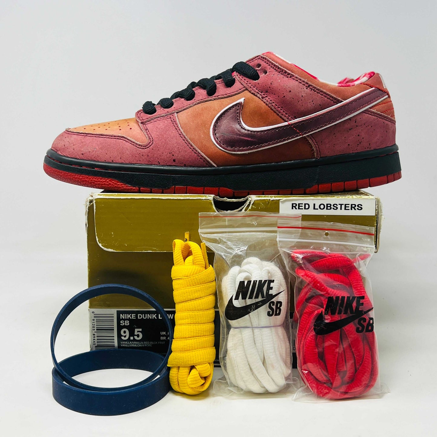 Nike SB Dunk Low Concepts Red Lobster with accessories and replacement box.