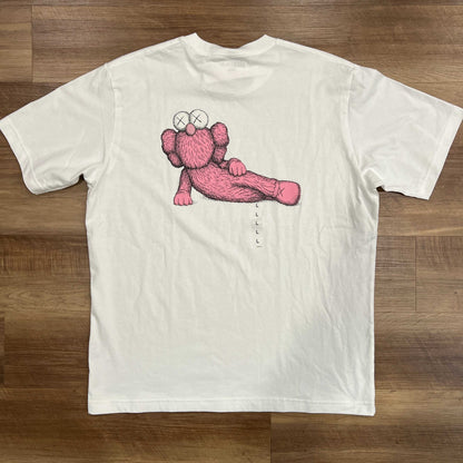 KAWS x Uniqlo Kids white graphic T-shirt with pink character, size L, brand new.