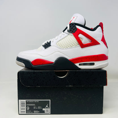 The Jordan 4 Retro Red Cement sneaker, white with red and black accents and featuring visible air cushioning and signature side netting, is displayed on its immaculate black shoebox. The box label indicates a size 9.