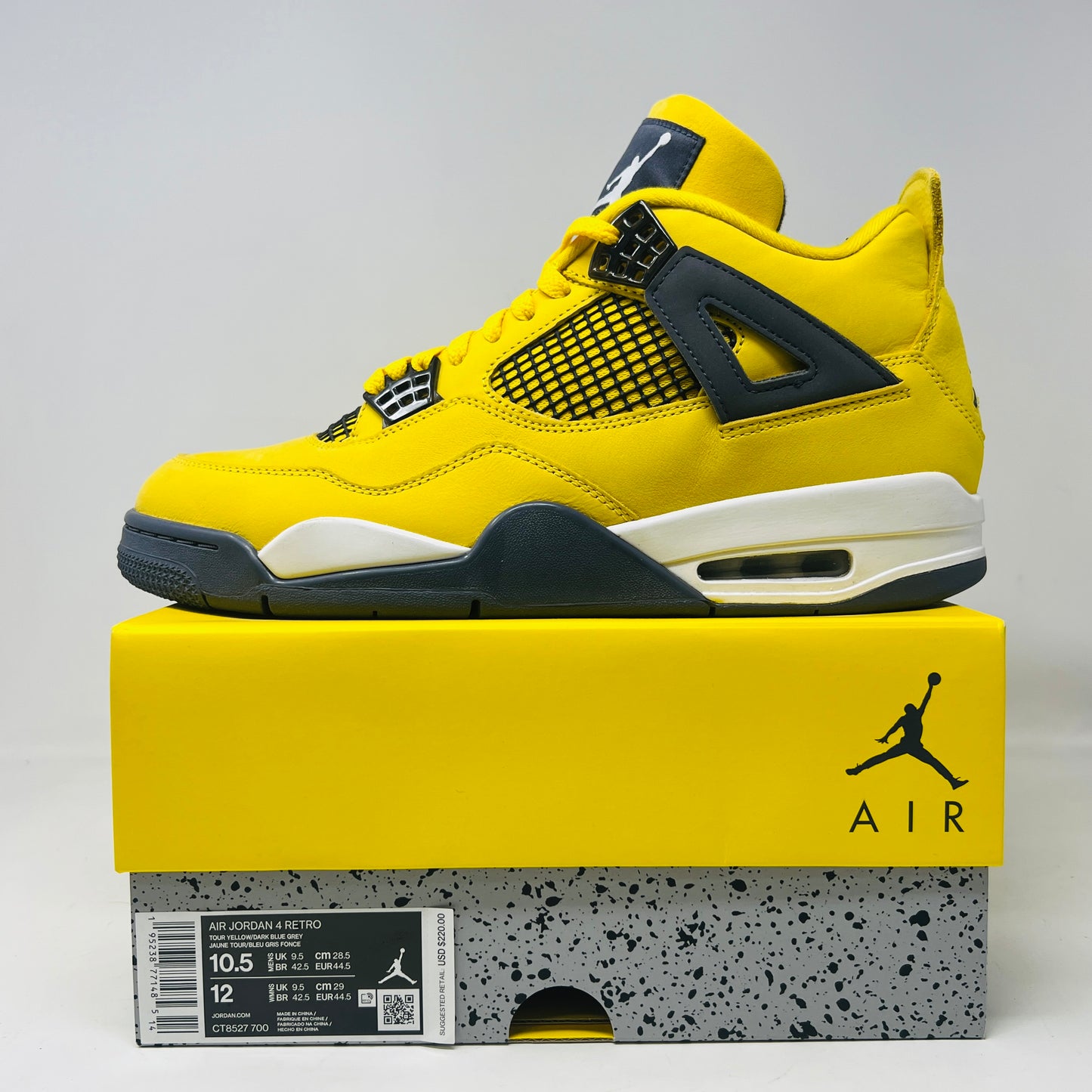 The Jordan 4 Retro Lightning (2021) in yellow, worn once and still pristine with its box, features black accents, a white midsole, and visible air cushioning. Sizes 10.5 and 12 are labeled alongside the Jumpman logo on both the sneaker and matching yellow box.