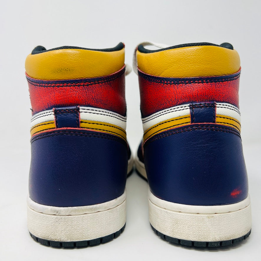 Rear view of Jordan 1 Retro High OG Defiant SB LA to Chicago sneakers by Jordan in red, yellow, blue, and white. They have a white sole with black treads, and a layered design against a plain white background.