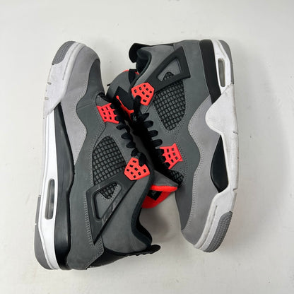 A pair of genuine Jordan 4 Retro Infrared sneakers in gray, black, and infrared is displayed on a speckled shoebox. Released in 2022, they feature a unique side mesh and infrared lace locks. The box labels them as size 9; note there are no returns.