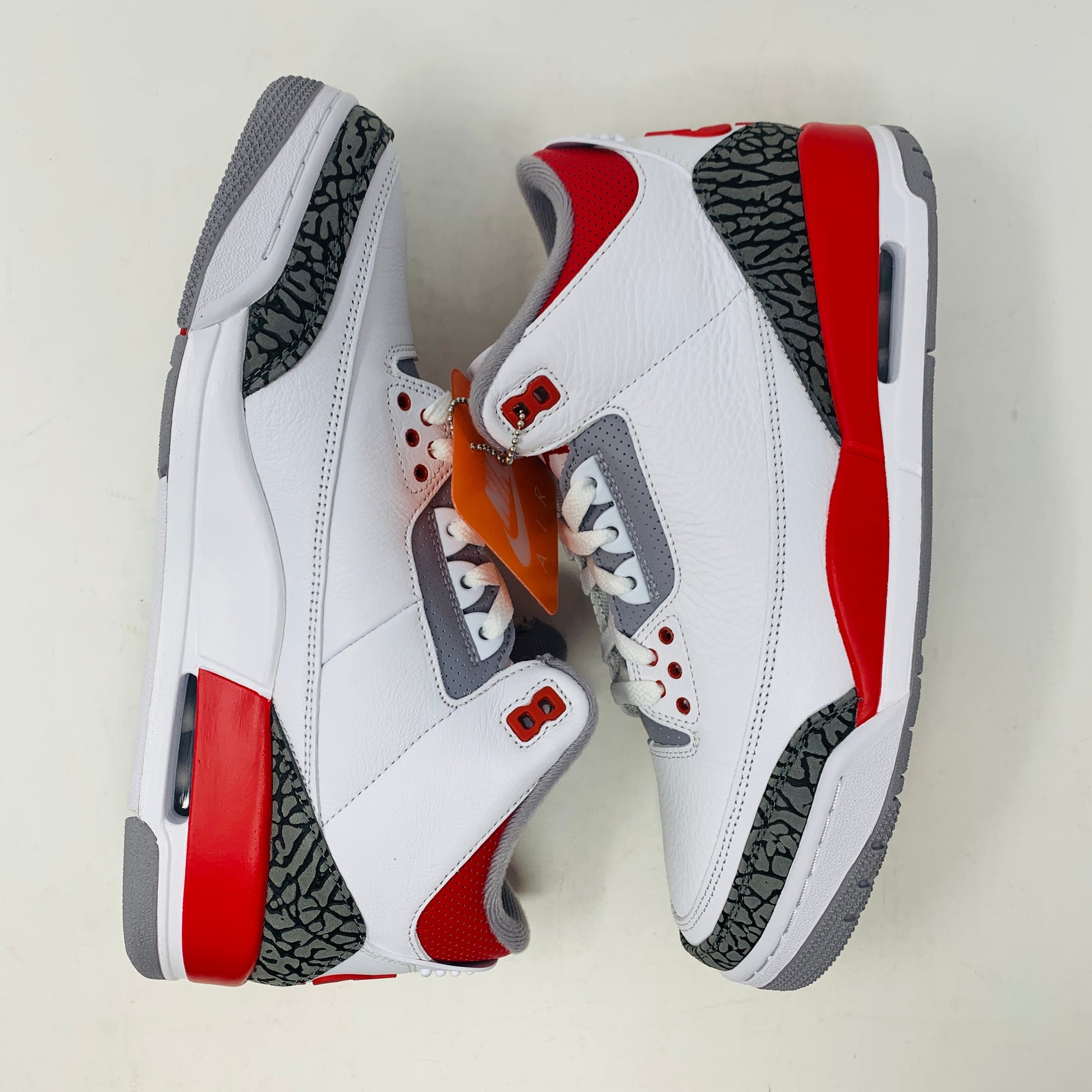 Jordan 3 Fire Red 2022 sneaker with white leather, red accents, and elephant print details.