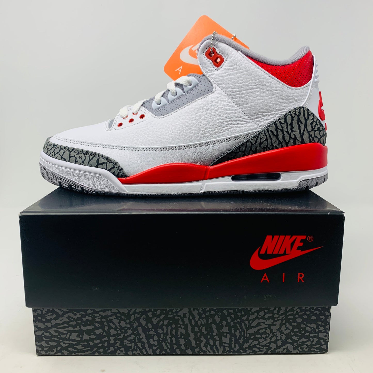 Jordan 3 Fire Red 2022 sneaker with white leather, red accents, elephant print detailing, and Air-Sole unit.