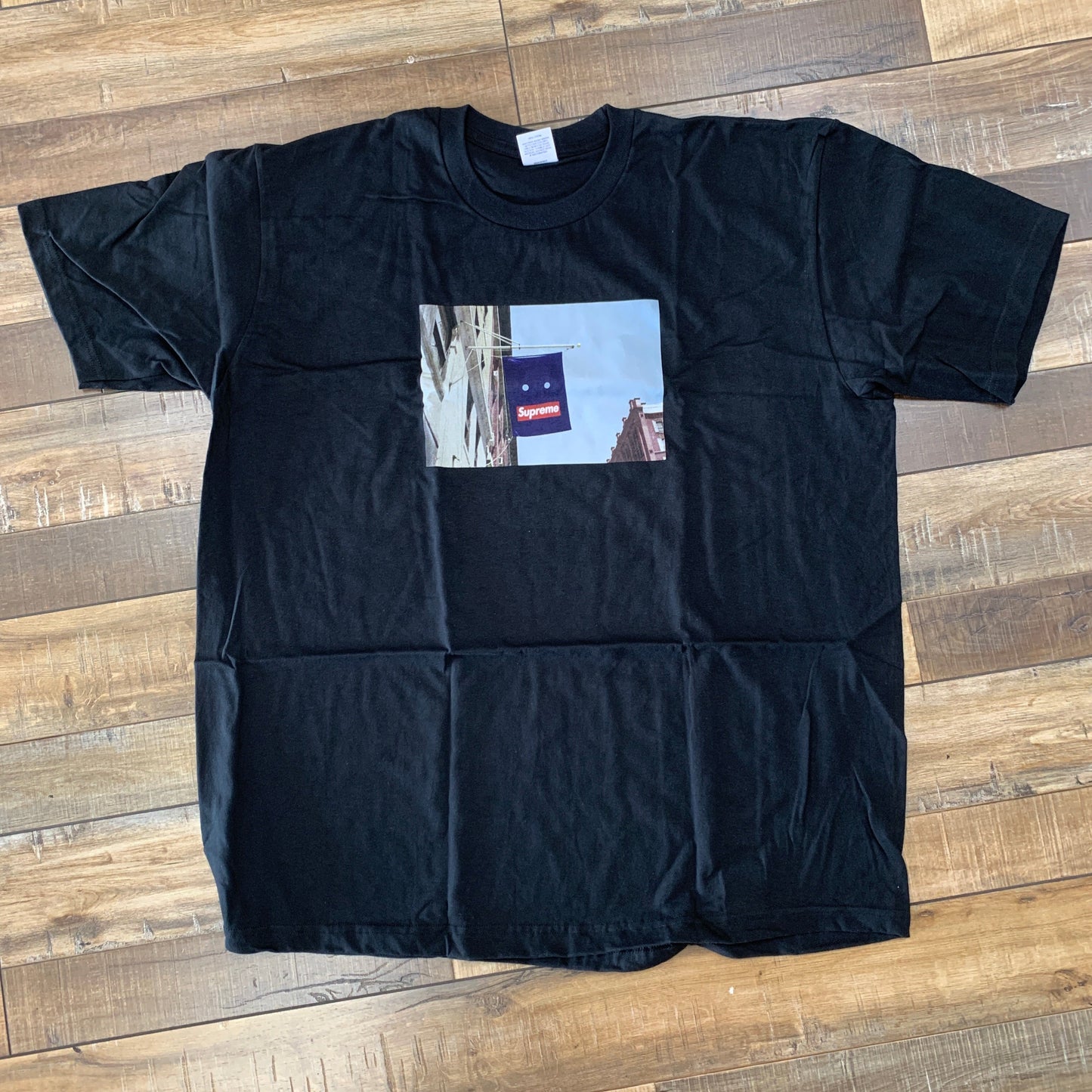 Supreme Banner Tee Black, brand new condition, featuring iconic streetwear design.