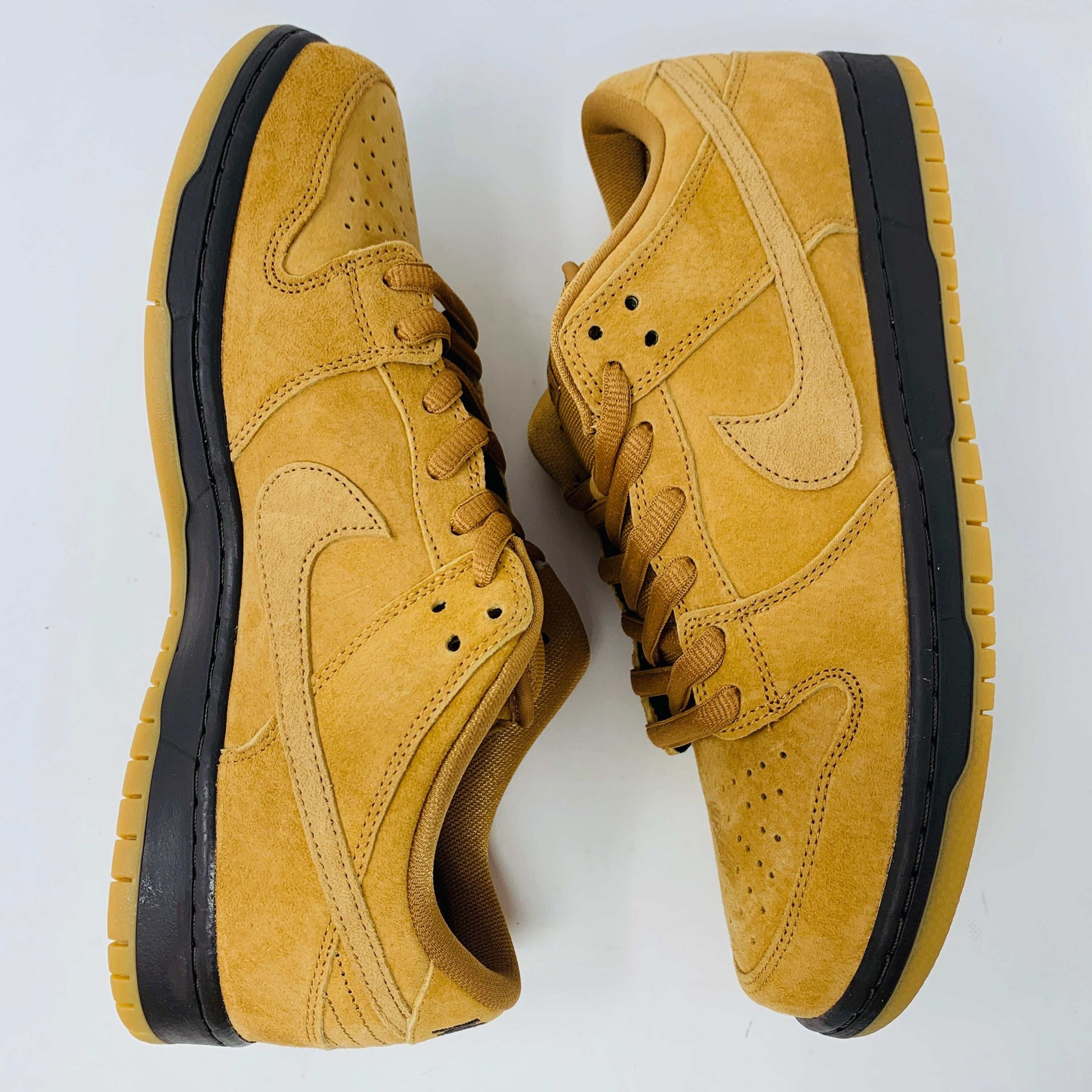 Nike SB Dunk Low Wheat 2021/2023 sneakers in wheat-colored suede with classic low-top design and white midsole.