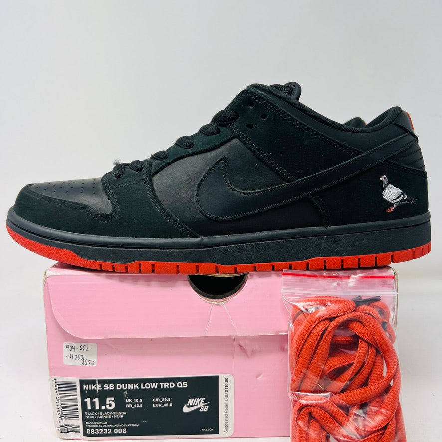 Nike SB Dunk Low Black Pigeon sneaker with pigeon logo on heel, black design, and red sole.