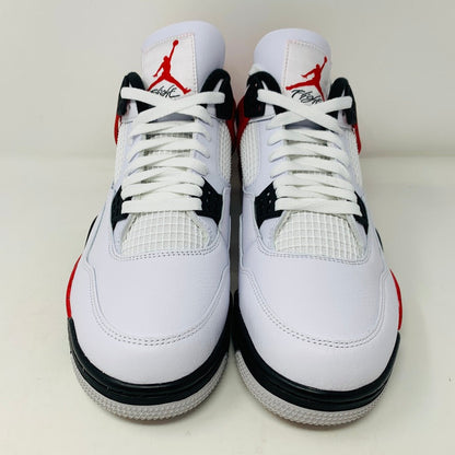 The Jordan 4 Retro Red Cement athletic shoes showcase a white and red design with black accents, highlighted by the Air Jordan logo on the tongue. Displayed against a plain backdrop, these sought-after sneakers feature white laces and a netted style, reminiscent of the Red Cement collection.