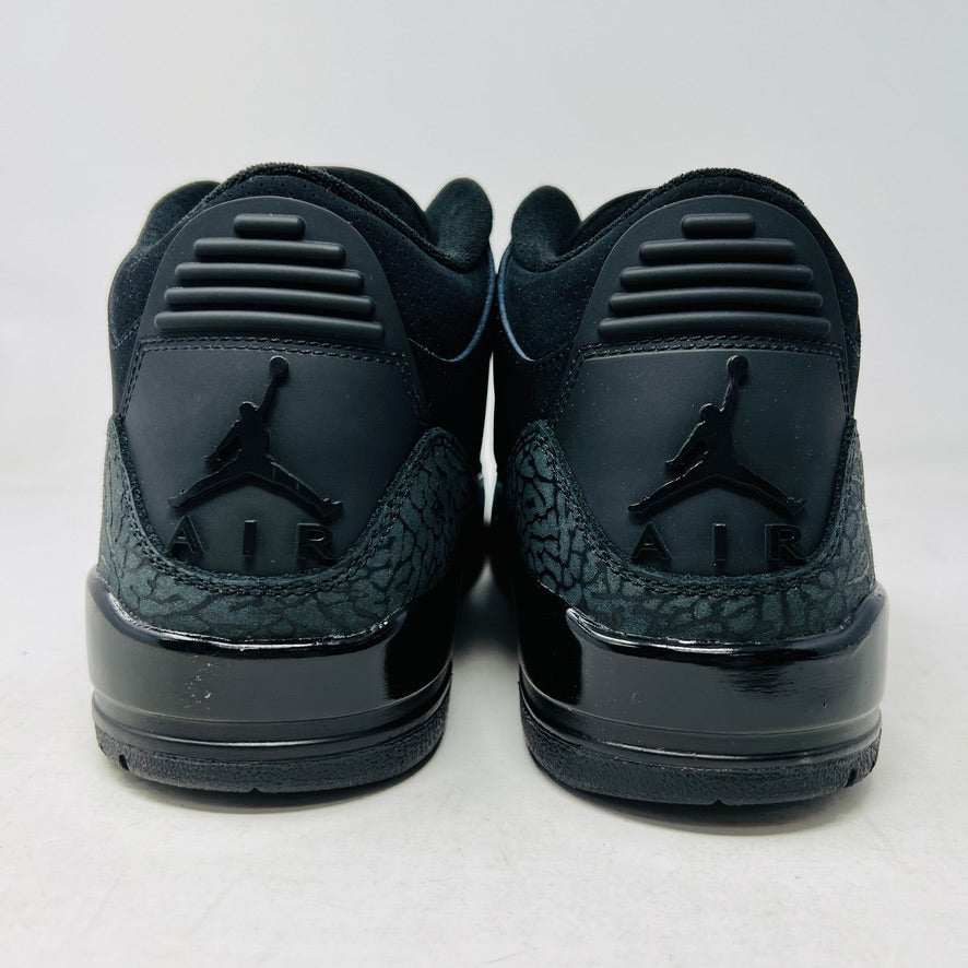 The Jordan 3 Retro Black Cat (2025) sneaker, featuring a glossy finish and elephant print accents, sits on a black box with the red Jumpman logo. This brand new, 100% authentic release from Jordan ensures style and exclusivity.