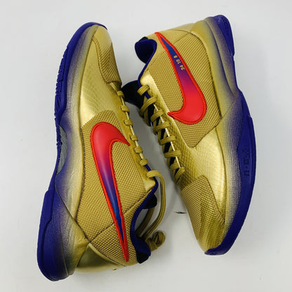 The Nike Kobe 5 Protro Undefeated Hall of Fame sneaker features a gold and purple design with a red swoosh, numbers 24 10 8 on the side, and comes with extra purple laces atop an orange box—100% authentic and perfect for any collection.