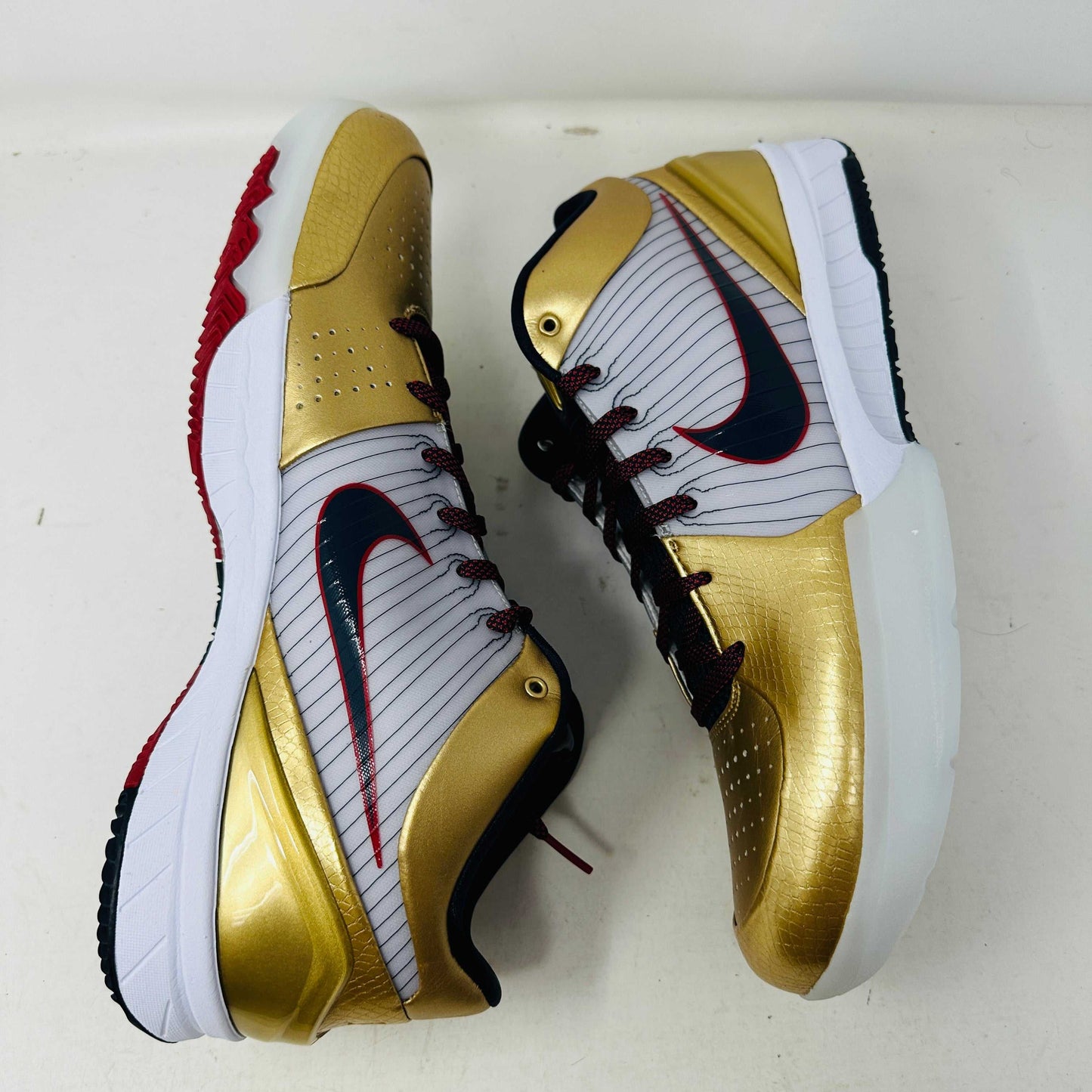 Nike Kobe 4 Protro Gold Medal 2024 basketball shoes in gold and black colorway.