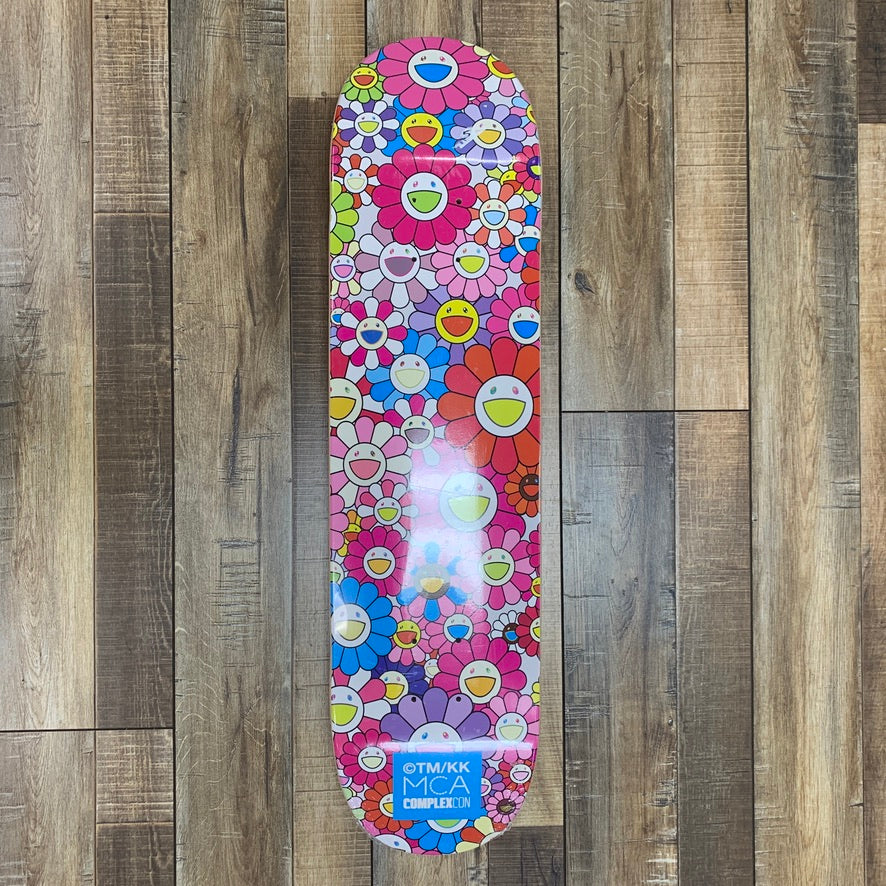 Takashi Murakami Flower Skateboard Deck Pink on wooden floor.