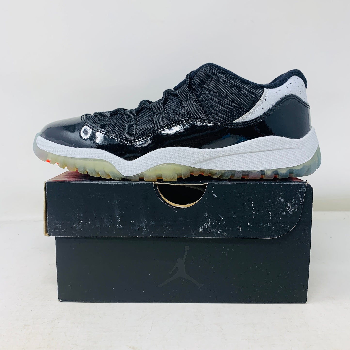 Jordan 11 Retro Low Infrared (PS) sneaker in black and infrared on box.