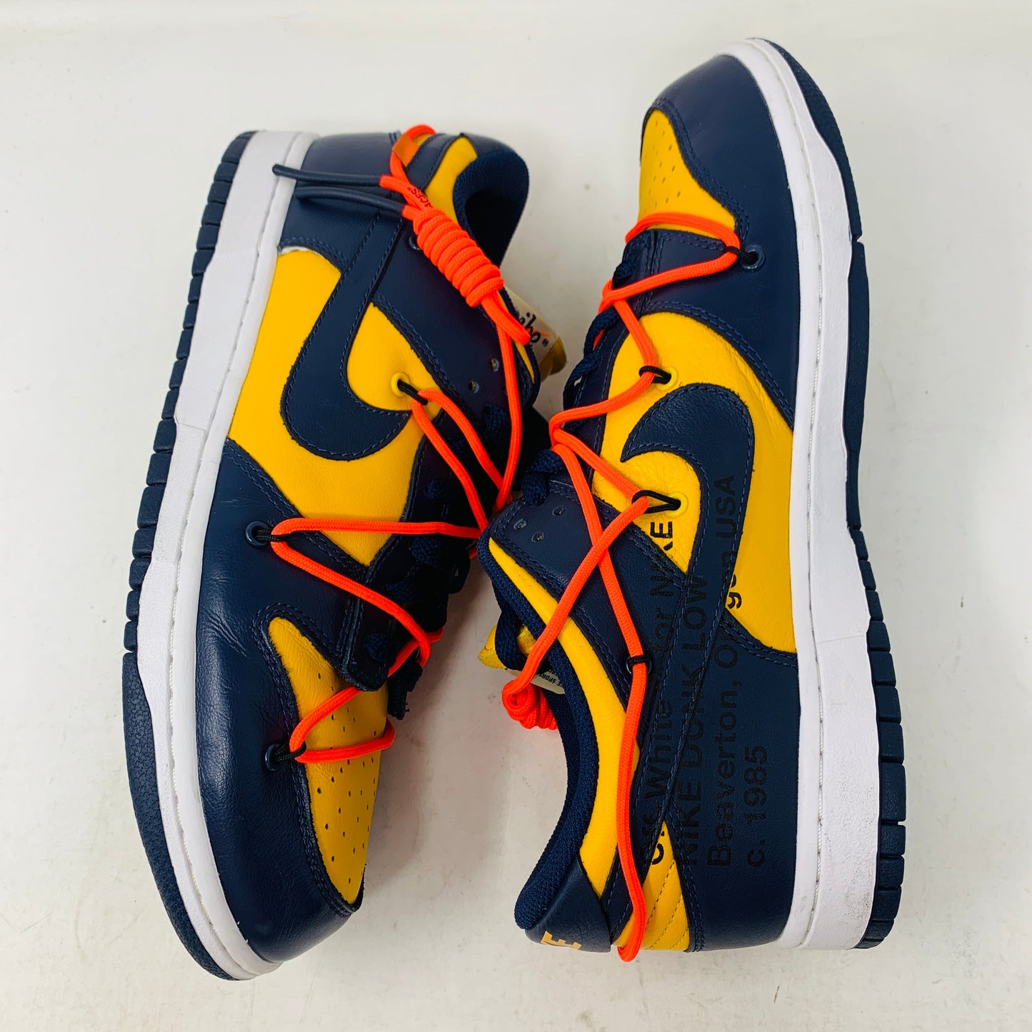 Nike Dunk Low Off-White University Gold sneakers with blue and yellow design and orange laces.