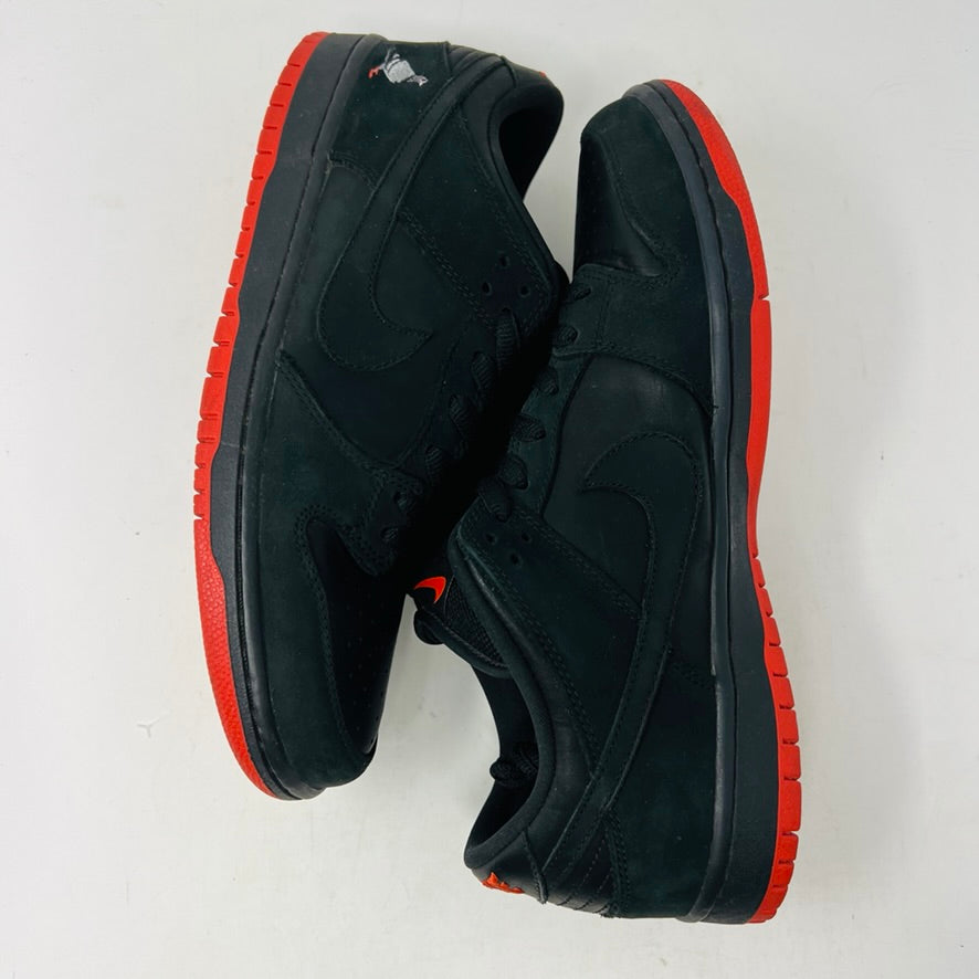 Nike SB Dunk Low Black Pigeon sneakers with black design and red soles.