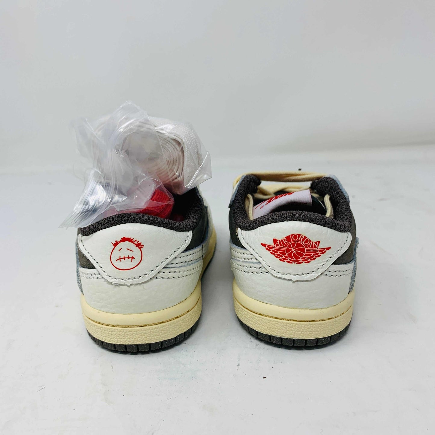 Jordan 1 Low TS Reverse Mocha TD sneakers for kids, rear view of shoes showing unique design.