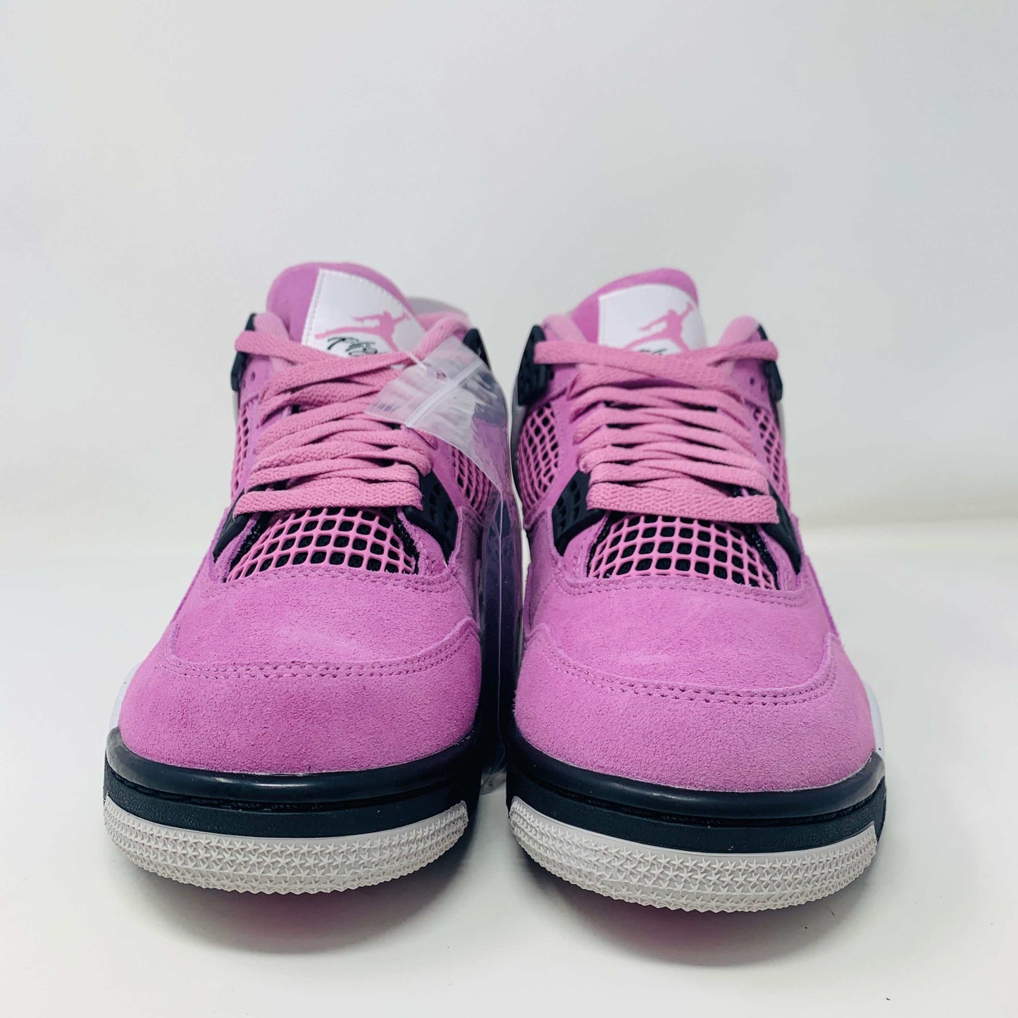 Women's Jordan 4 Retro Orchid sneakers in pink with black accents.