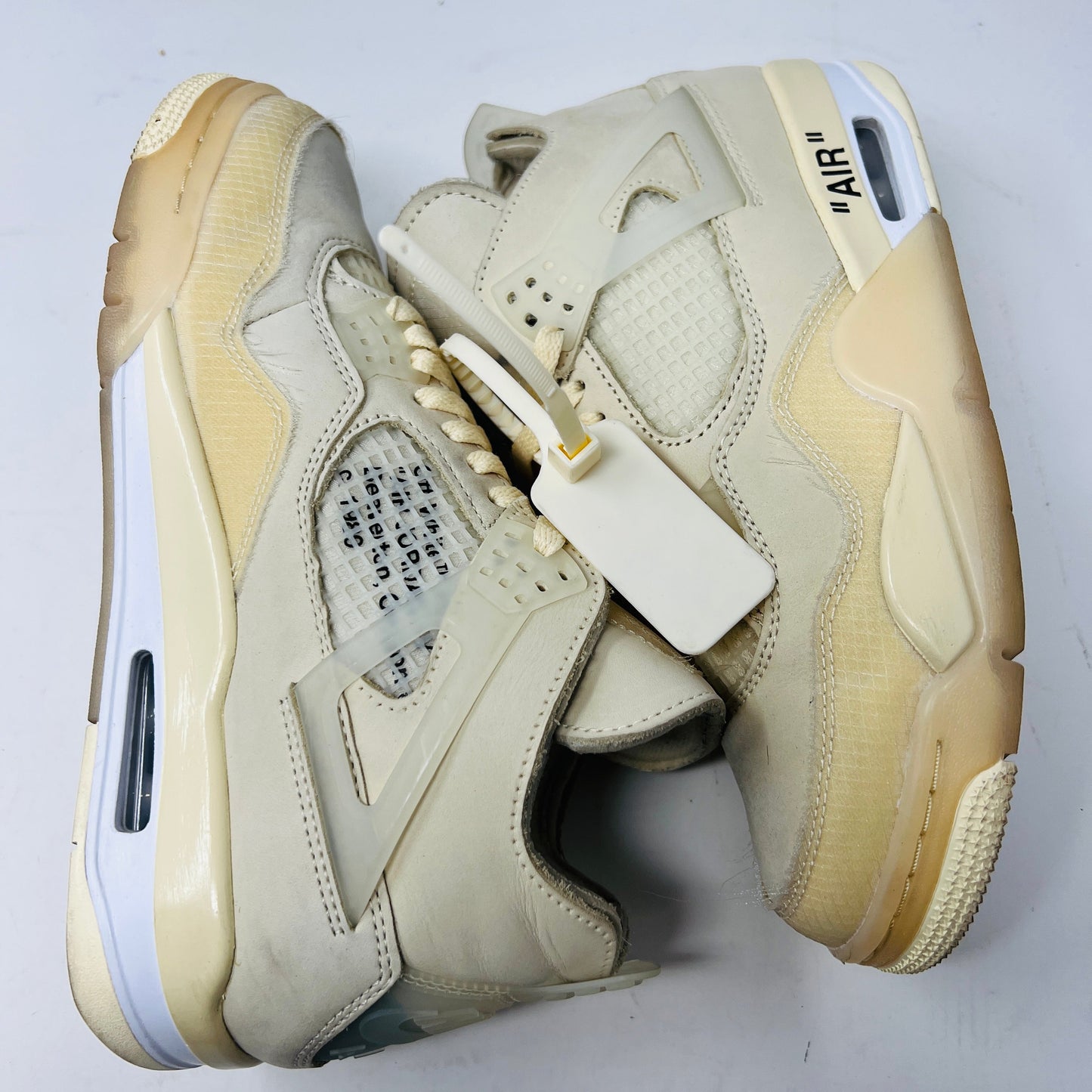 Jordan 4 Retro Off-White Sail Women's sneakers with premium materials and signature design.