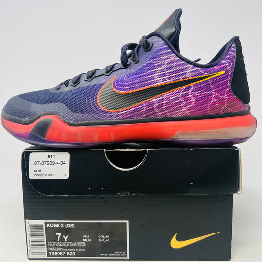 The Nike Kobe 10 Hero (GS) sneaker from 2015 in purple and pink with orange accents rests on a black shoebox. It features clean uppers, a prominent black Nike swoosh, and sits atop a translucent red sole. The size label reads 7Y, indicating light wear.