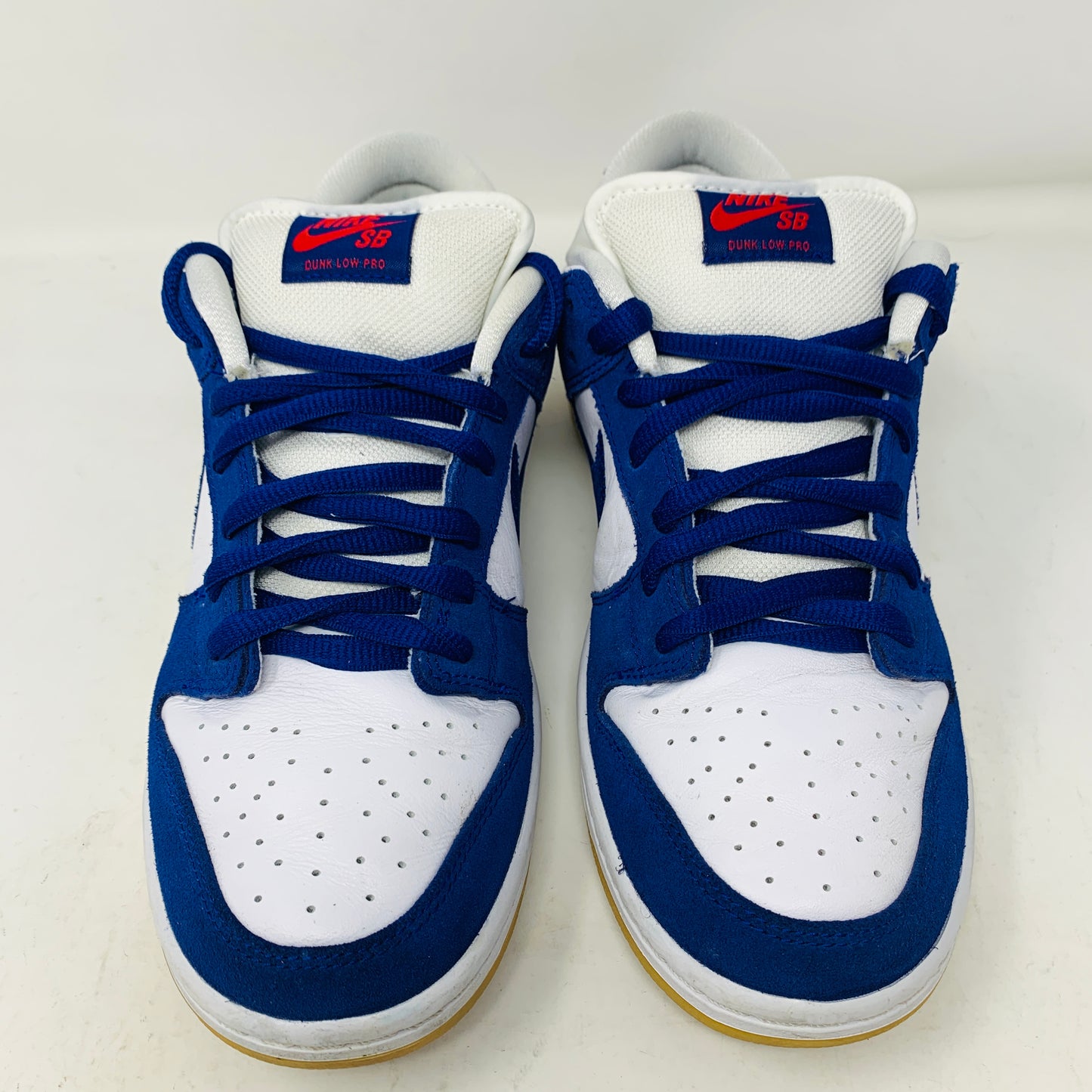 The 2022 Nike SB Dunk Low Los Angeles Dodgers by Nike has authentic blue and white leather panels, blue laces, and a white tongue with the red Nike SB logo, displayed side by side on a plain white background.