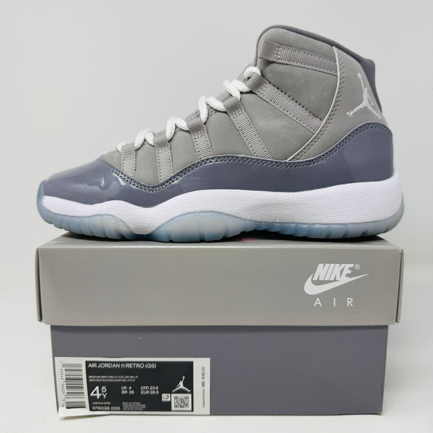 Jordan 11 Retro Cool Grey 2021 GS sneaker on box with Nike logo.