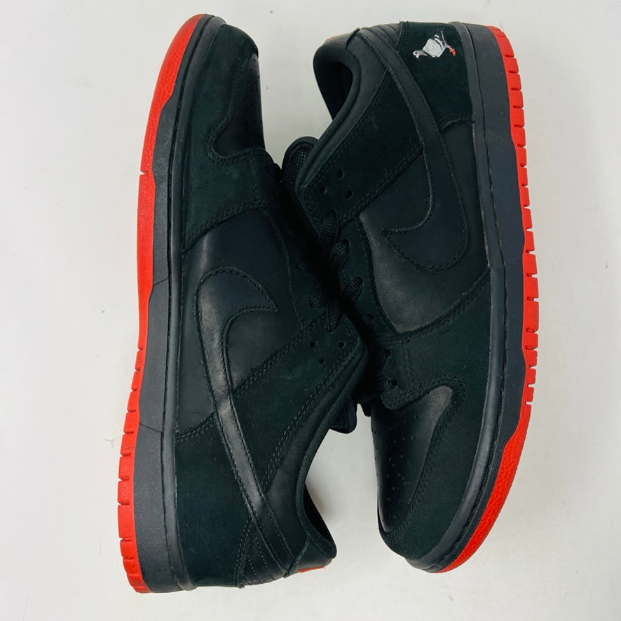 Nike SB Dunk Low Black Pigeon sneaker with black design and pigeon logo, red sole.