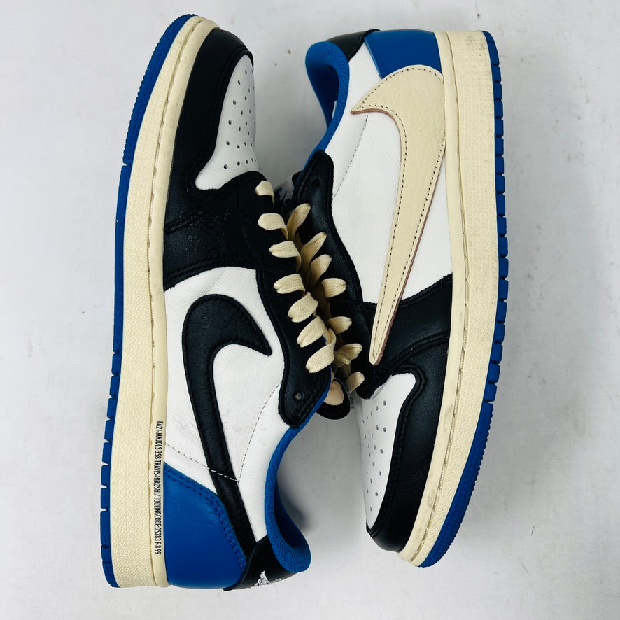 The Jordan 1 Retro Low OG SP Fragment x Travis Scott features a cream and black upper, blue heel and collar, and a cream sole with a signature swoosh design. Displayed against a plain backdrop without a box, it includes extra laces for versatility.