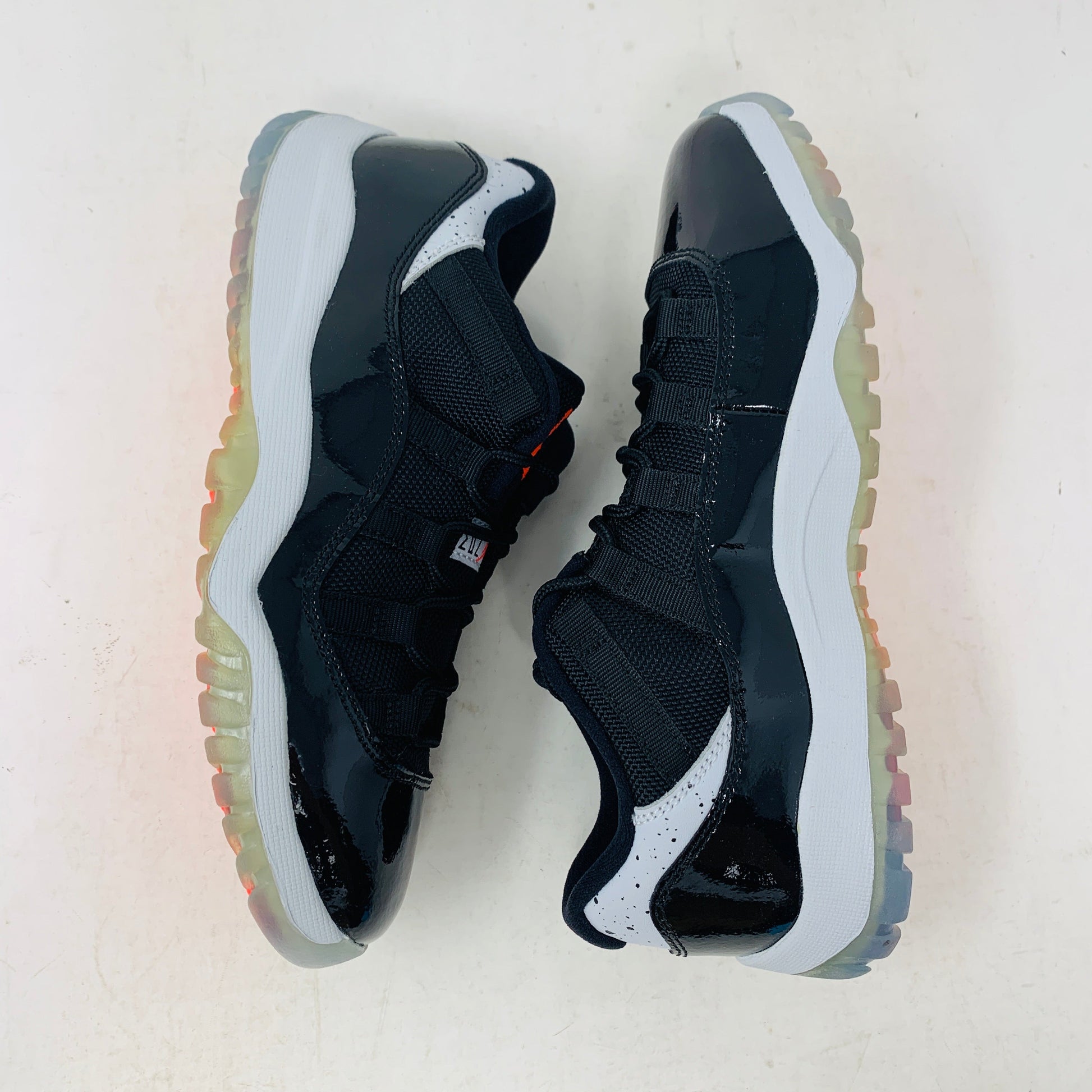 Jordan 11 Retro Low Infrared PS black and infrared sneakers with premium leather and mesh upper.