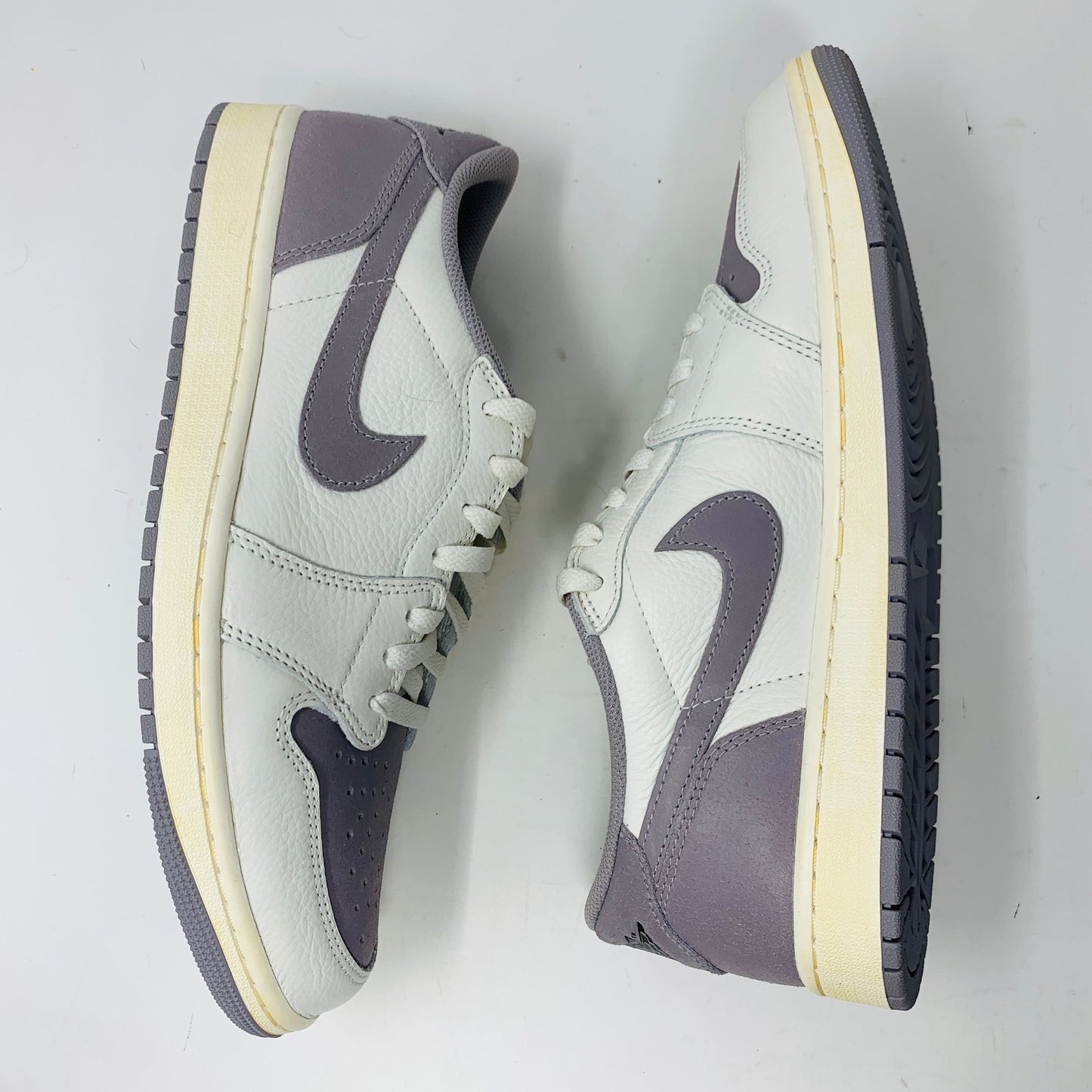 Jordan 1 Retro Low OG Atmosphere Grey sneakers, size 11, clean condition, 2023 model.