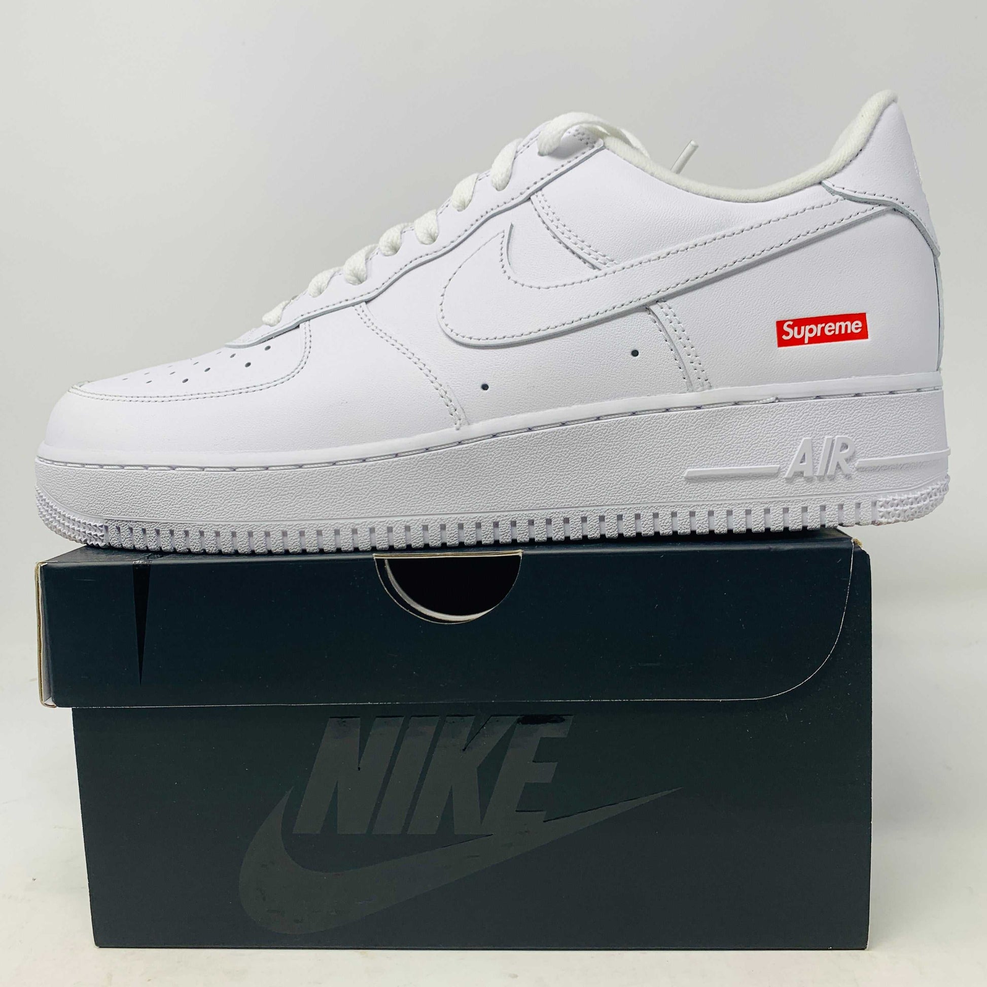 Supreme Air Force 1 White sneaker on a shoebox.