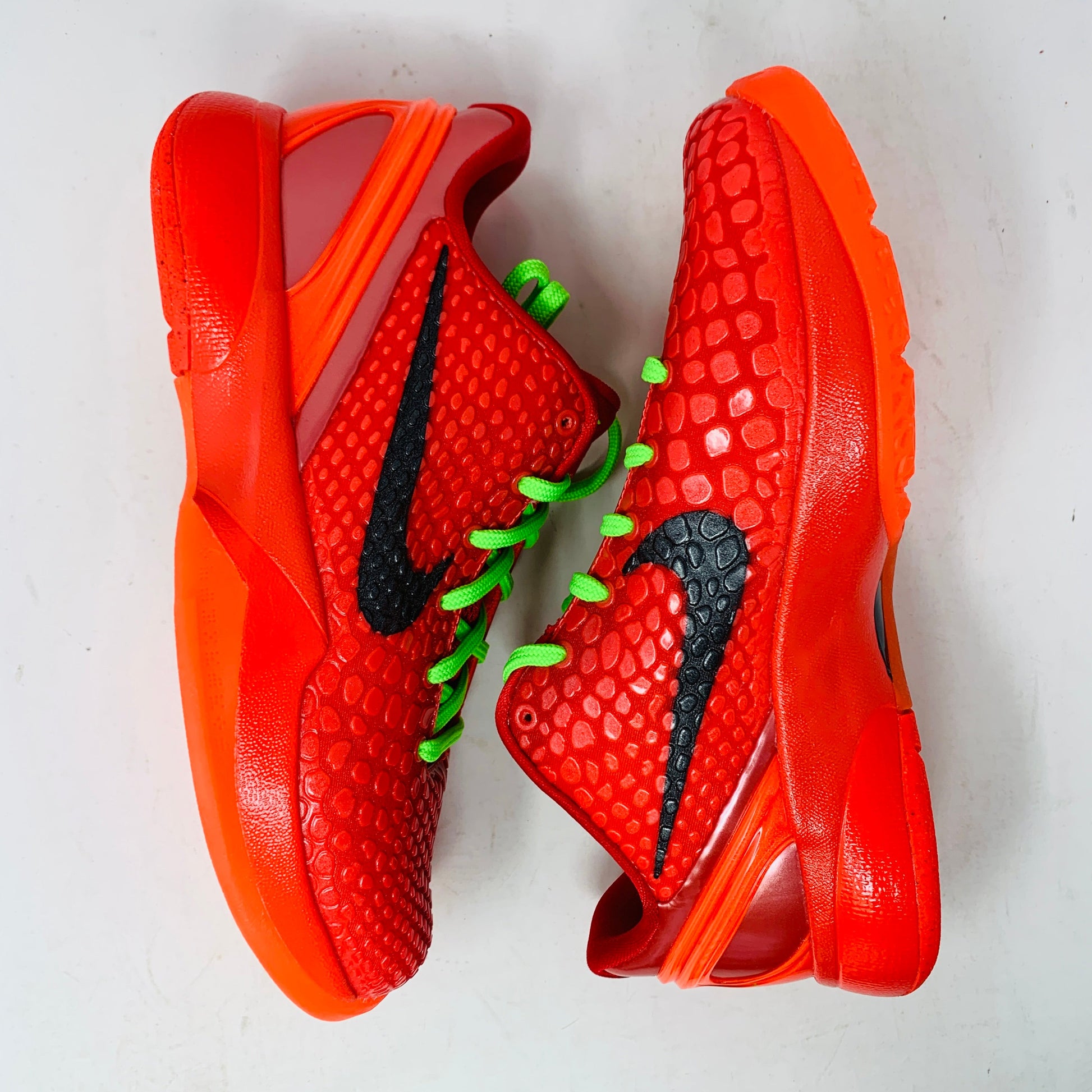 Nike Kobe 6 Protro Reverse Grinch GS basketball shoes in vibrant red and black colorway.