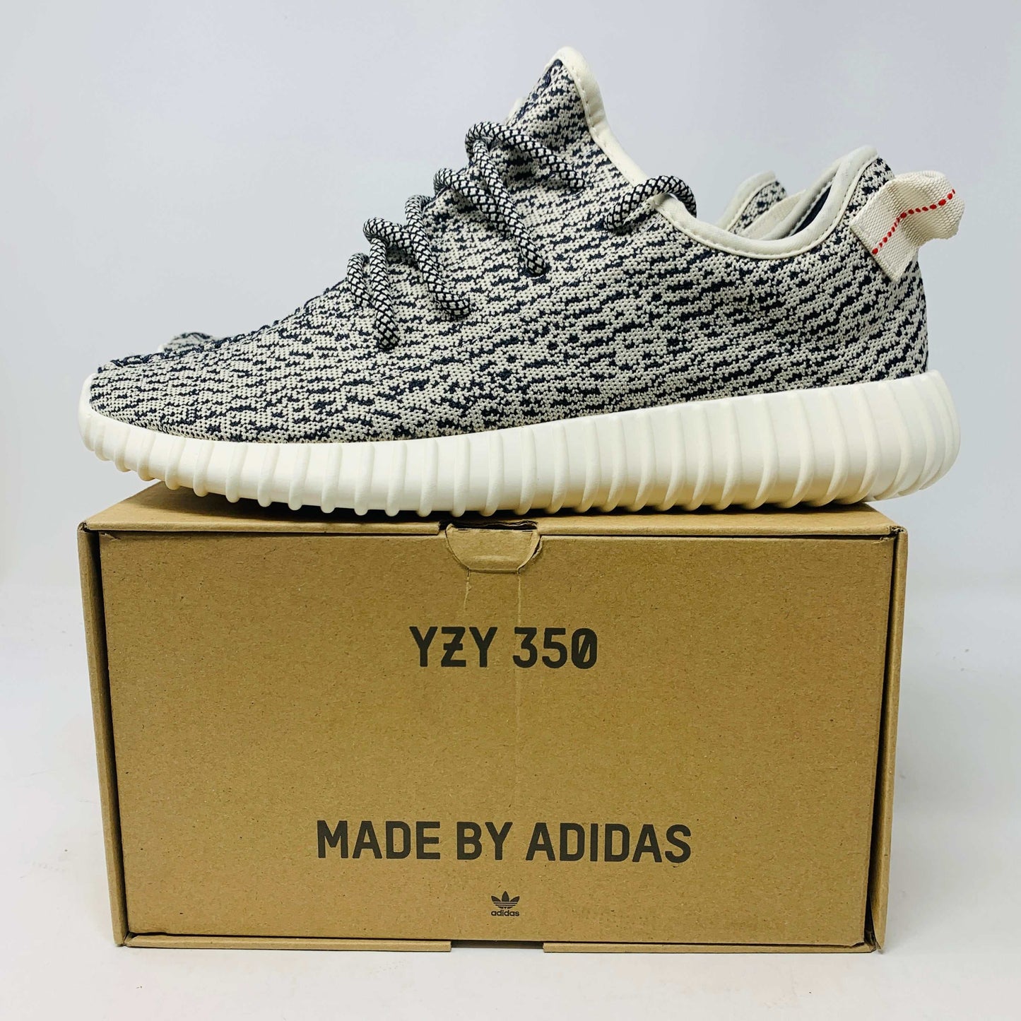 Yeezy Boost 350 Turtledove 2022 sneaker on box, showcasing sleek design and premium materials.