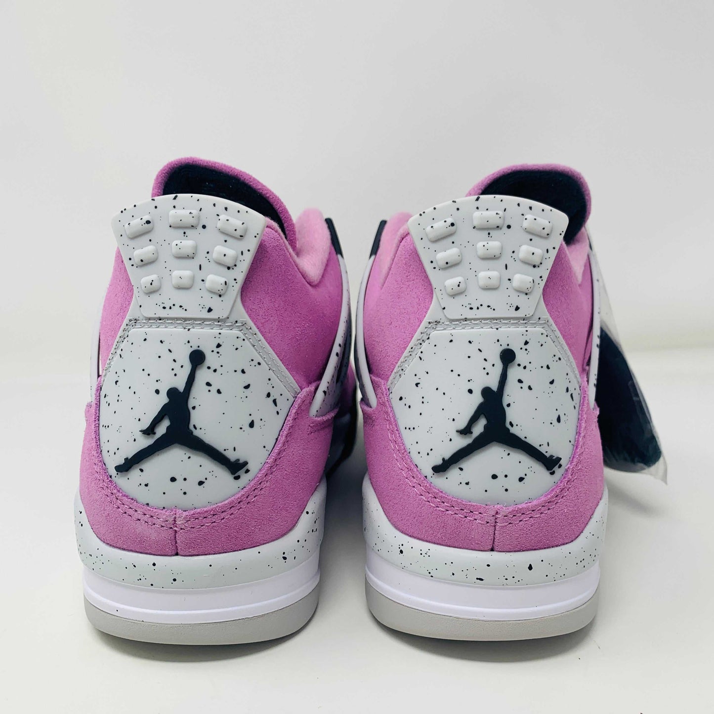 Women's Jordan 4 Retro Orchid sneakers in vibrant orchid colorway with classic silhouette and modern details.