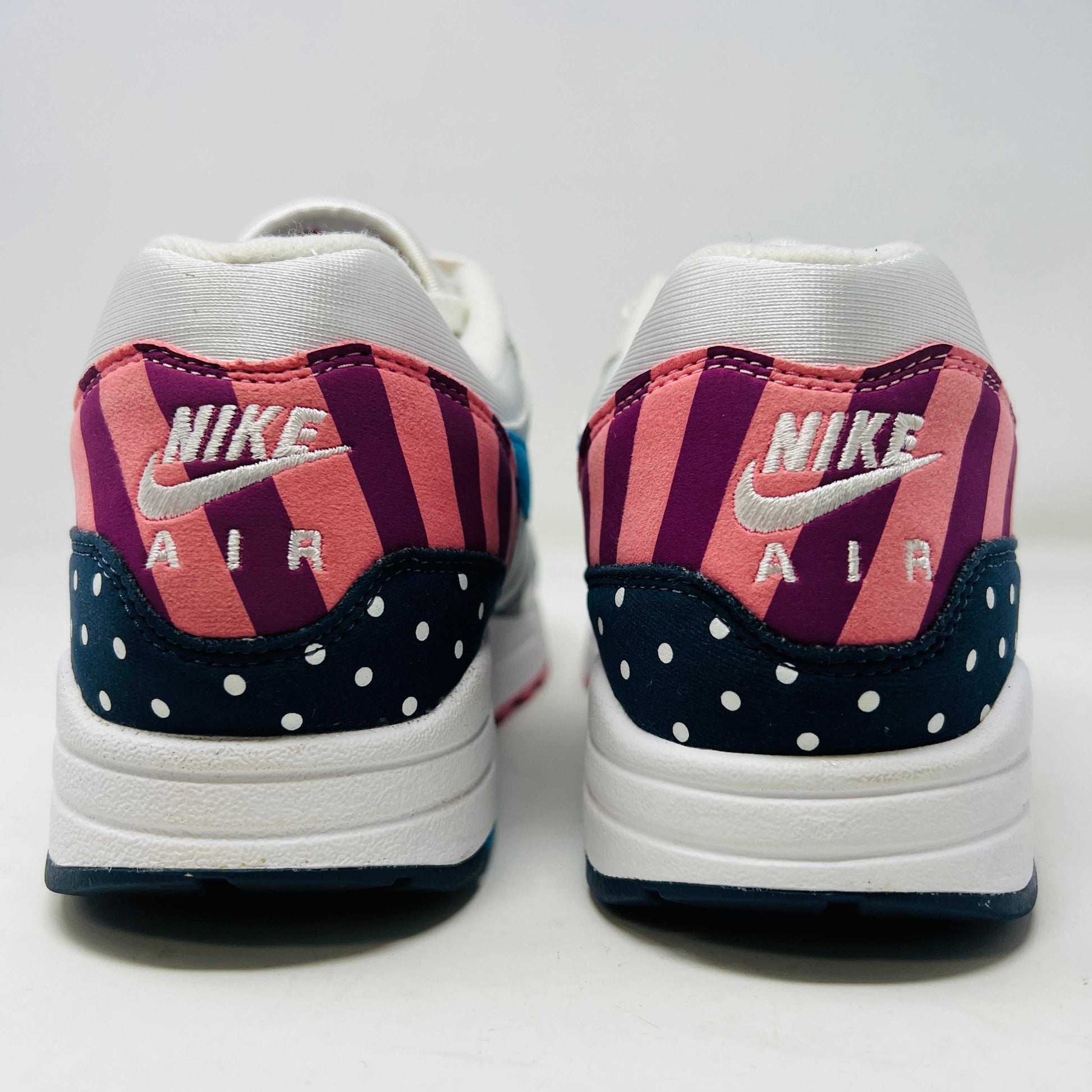 A Nike Air Max 1 Parra (2018) sneaker with clean uppers displaying stripes and polka dots sits on a box. The size 9.5 shoe features a blue swoosh and red, white, black accents, with visible original and discounted price tags ensuring authenticity.