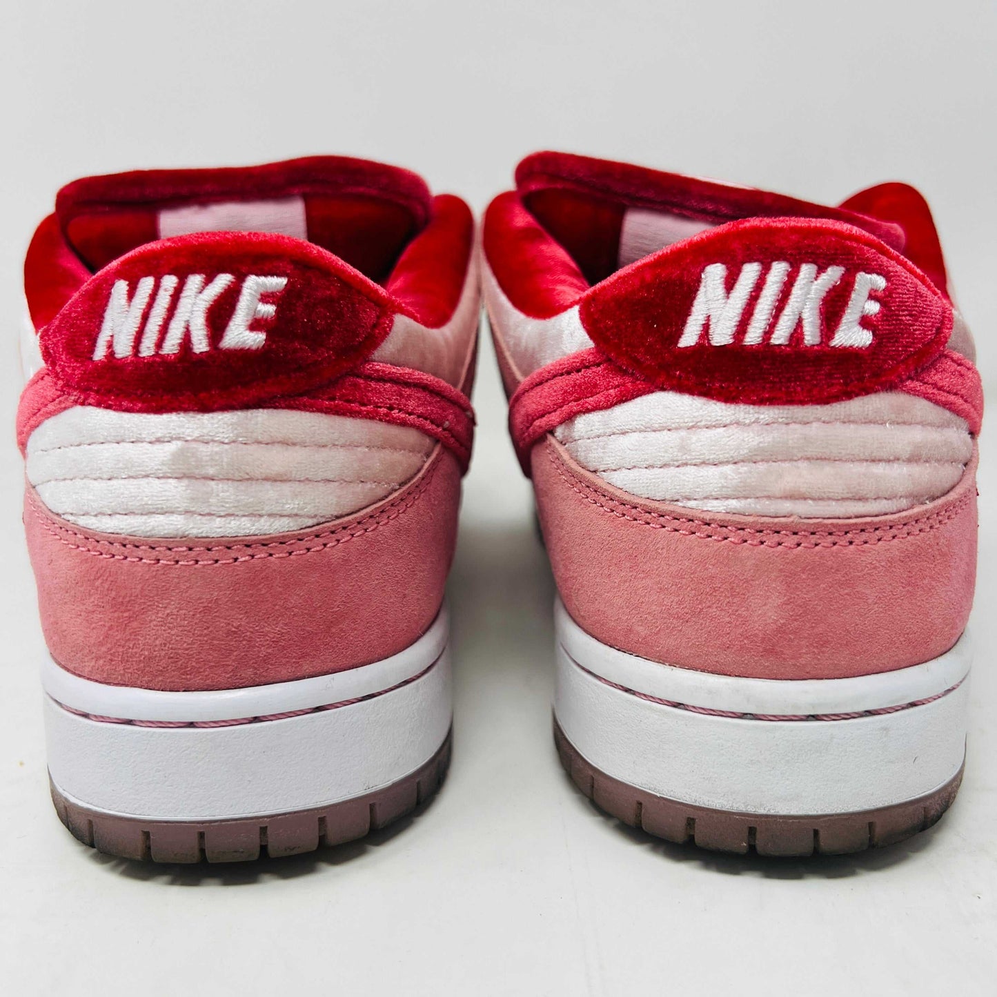 Nike SB Dunk Low StrangeLove Skateboards sneakers, size 9.5, rear view with red and pink details.