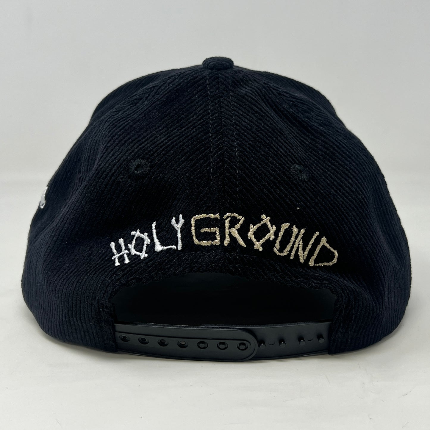 The Holy Ground Bones Hat Corduroy Black by Holy Ground features a ribbed texture, an embroidered crossed bones and A & B design, and a side white X. Its one-size ensures universal fit.