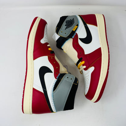 The Jordan 1 Retro High OG SP Union LA Chicago Shadow sneaker, featuring red, white, and gray sections with a black Nike swoosh, is displayed on a shoebox covered in shoe images. This BRAND NEW 2025 sneaker includes detailed stitching, a visible yellow tag, and comes with EXTRA LACES.