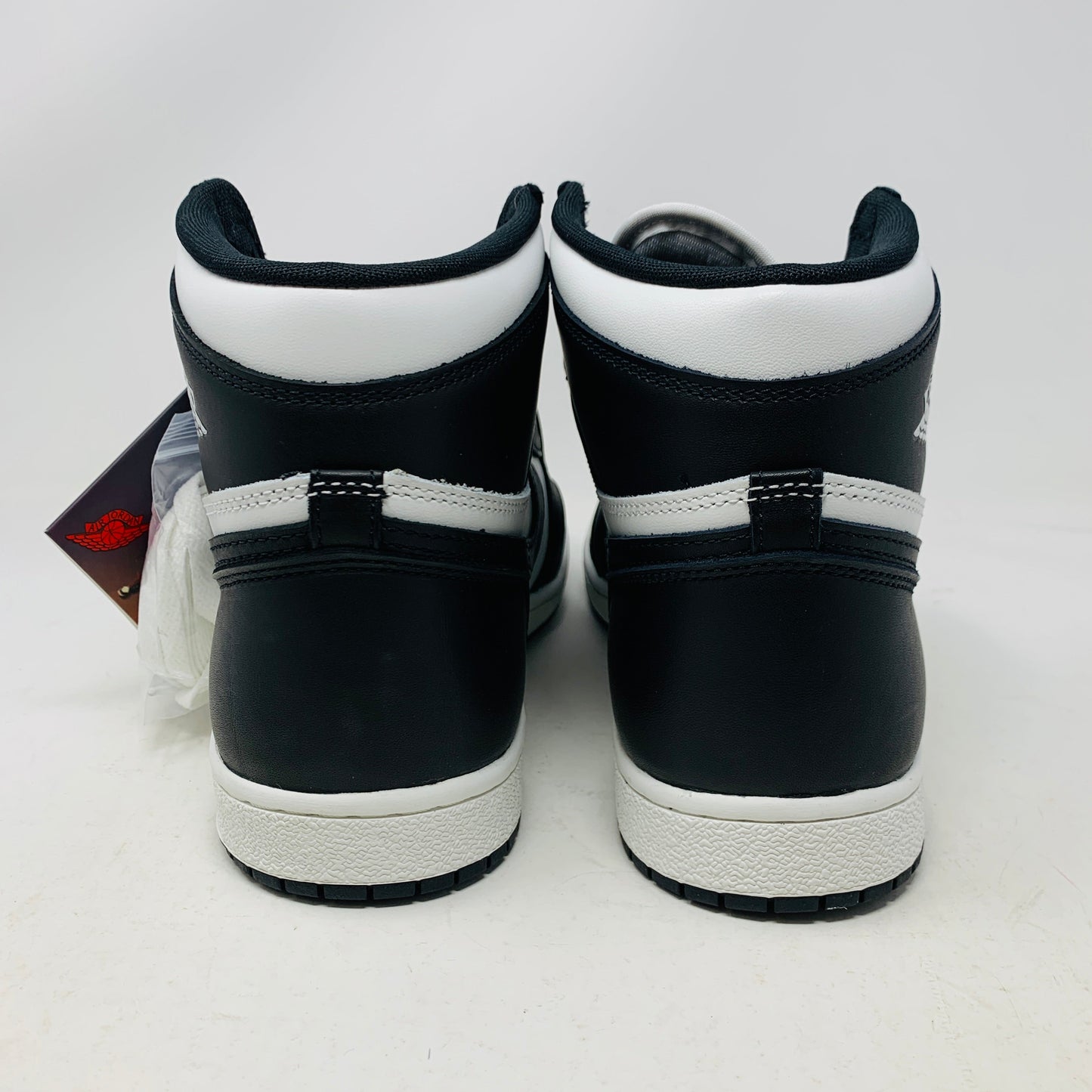 Jordan 1 Retro High 85 Black White 2023 sneakers rear view with box and extra white laces.