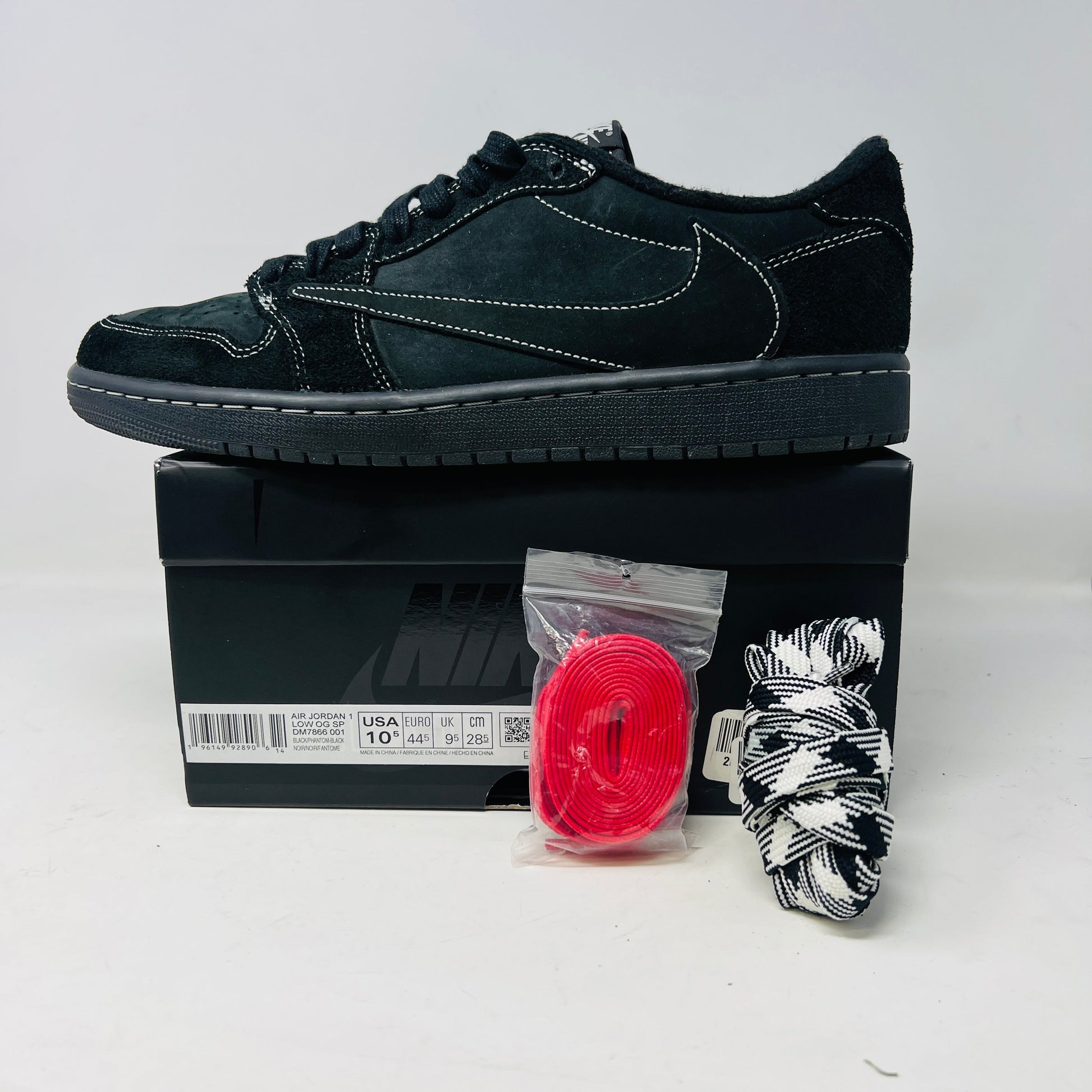 Jordan 1 Retro Low OG SP Travis Scott Black Phantom sneakers with accessories, 2022 model.