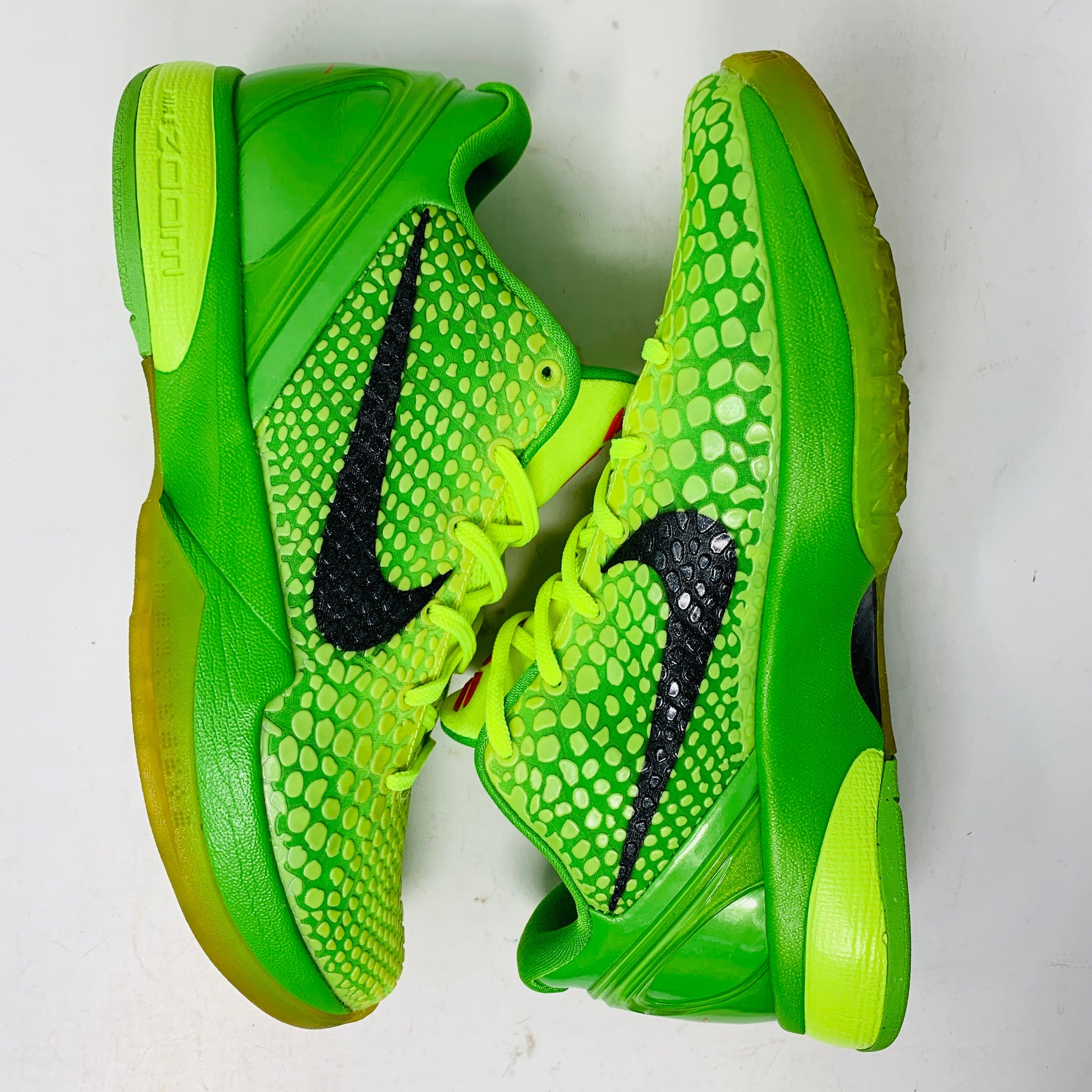 Bright green Nike Kobe 6 Grinch 2010 sneakers with black swoosh and minimal yellowing.