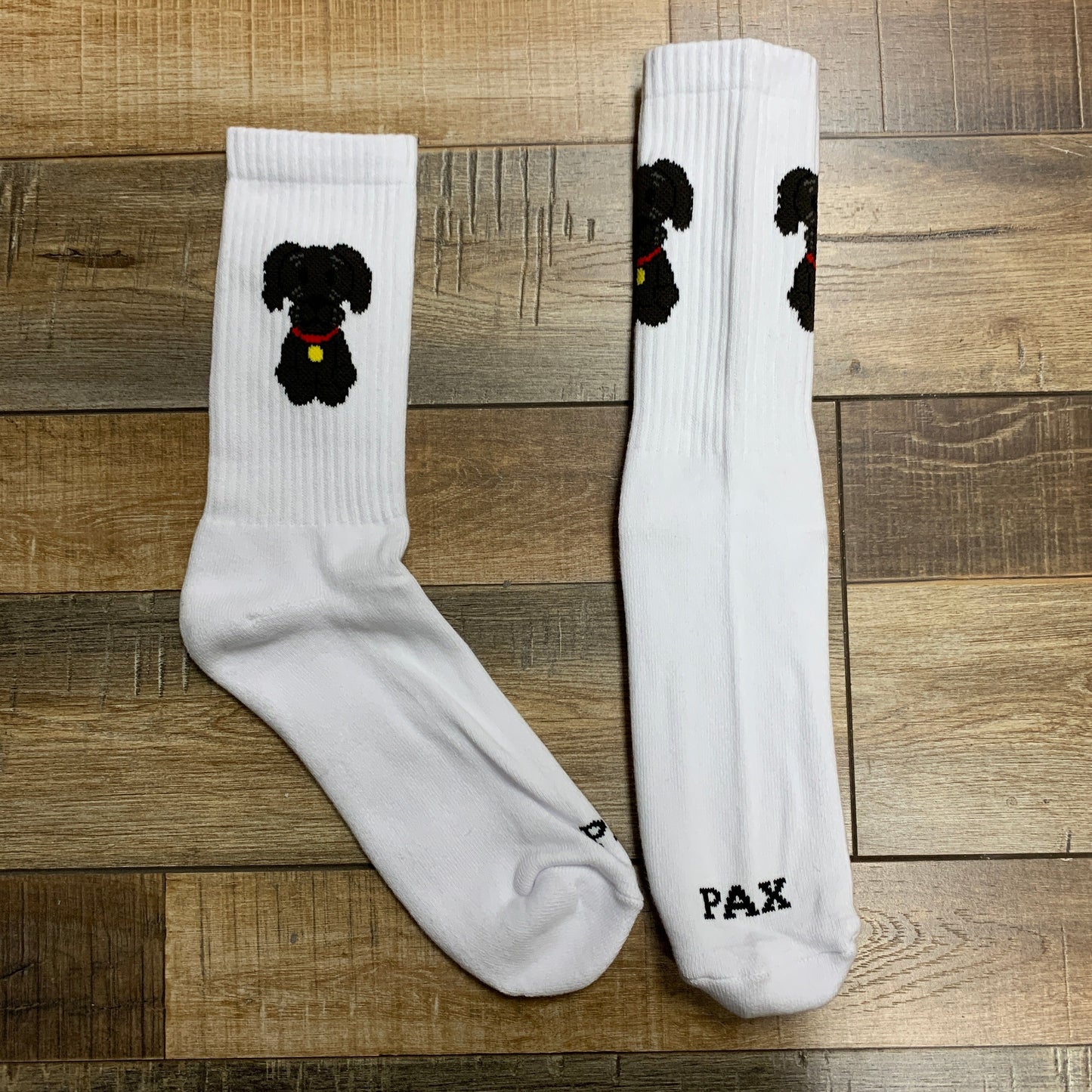 Holy Ground Socks with dog design on wooden floor