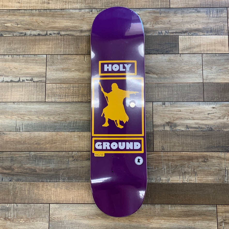 Holy Ground Laker Skate Deck with Laker logo on wooden floor background.