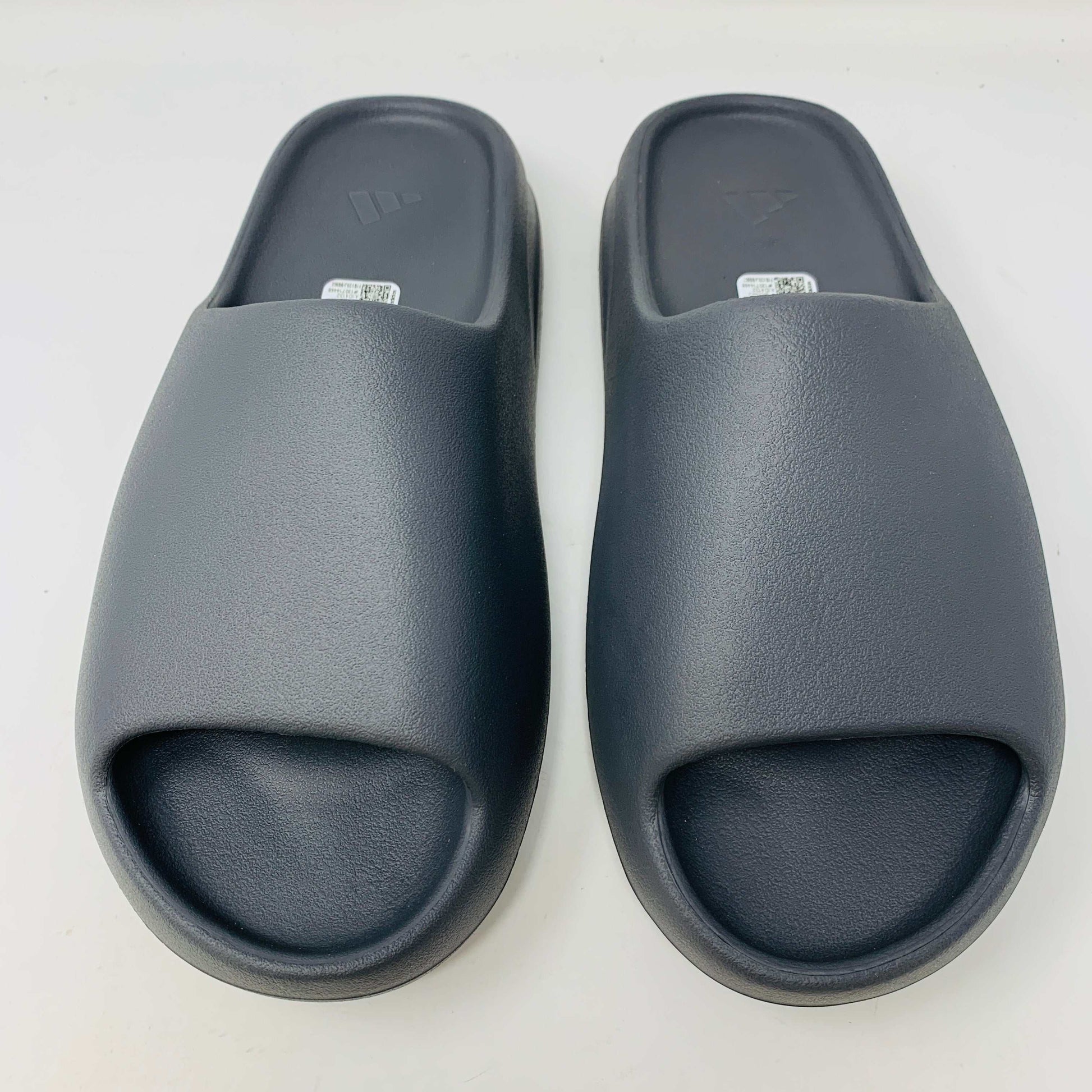 Adidas Yeezy Slide Granite in sleek granite colorway with Adidas logo, offering style and comfort for any occasion.