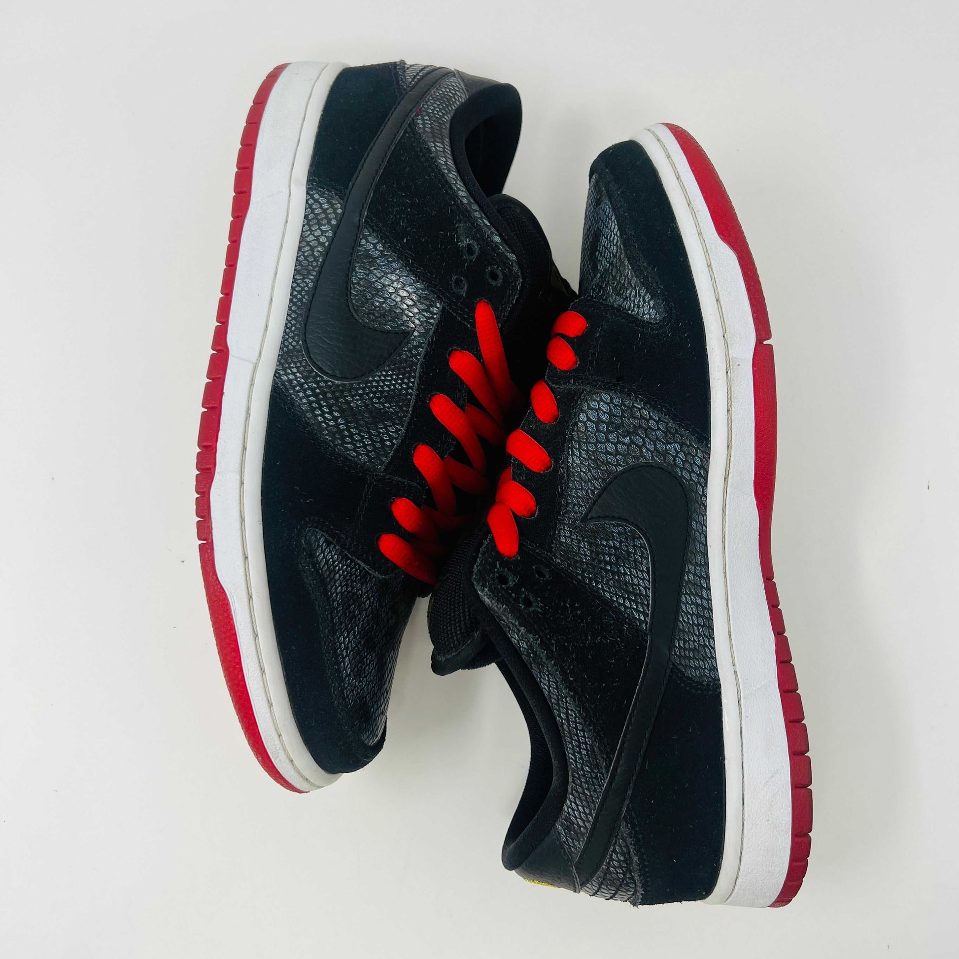 Nike SB Dunk Low Snake Eyes sneakers, size 9, black with red accents, showing minimal wear, no box, 2014 release.