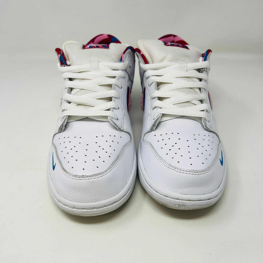 A white Nike SB Dunk Low Parra from 2019 with a multicolored swoosh rests on a black and teal box. The authentic shoes feature clean uppers, size 10.5, as indicated on the label.